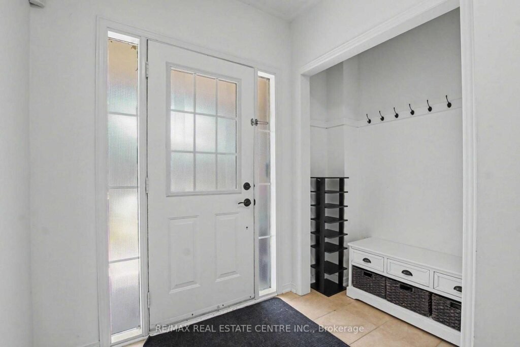 94 Timbertop Crescent, Brampton - front foyer with entry door and mudroom bench
