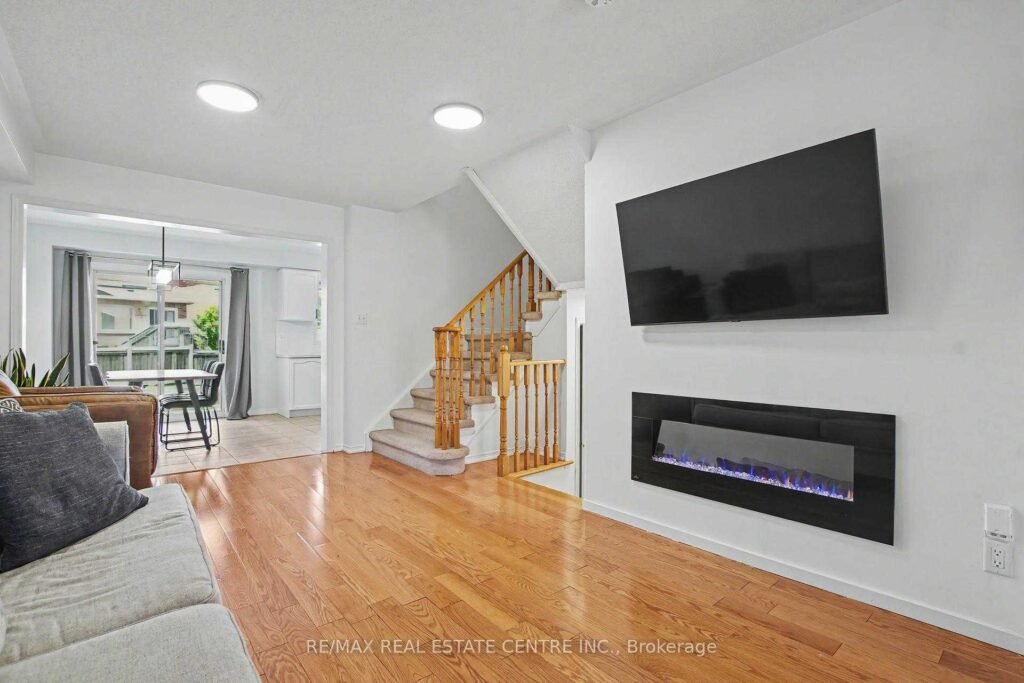 94 Timbertop Crescent, Brampton - living room with contemporary electric fireplace and hardwood floors