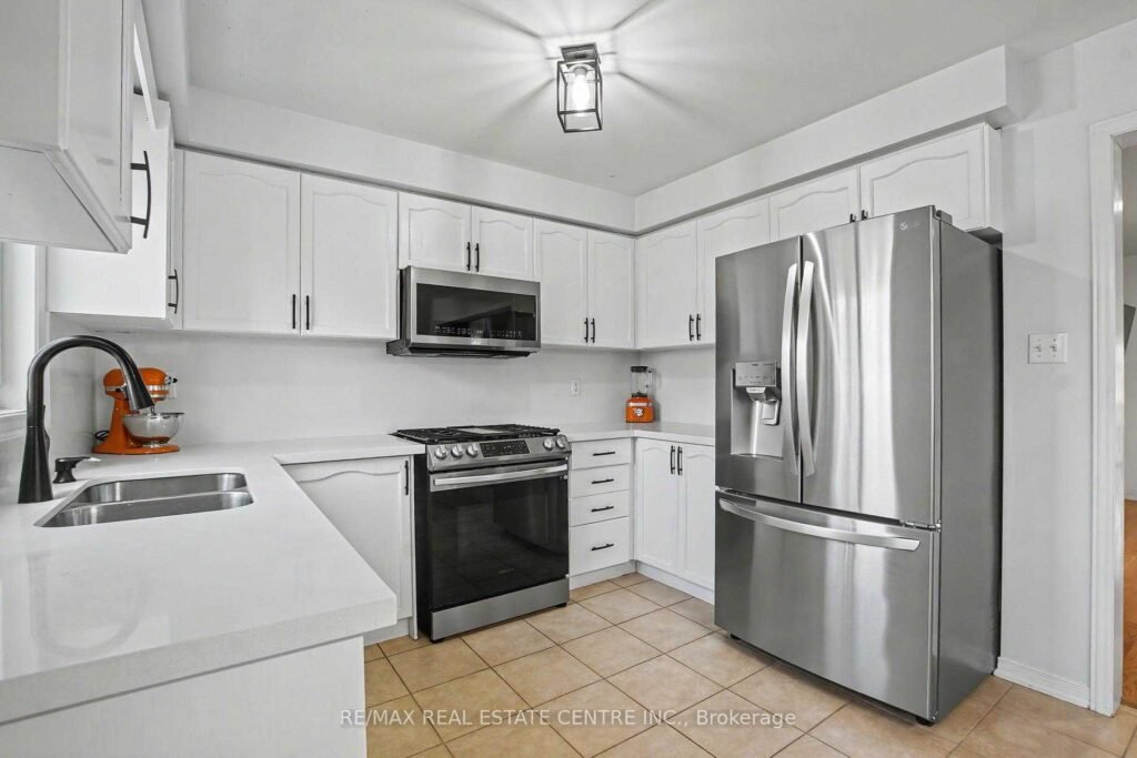 94 Timbertop Crescent, Brampton - kitchen with quartz countertop and stainless steel refrigerator