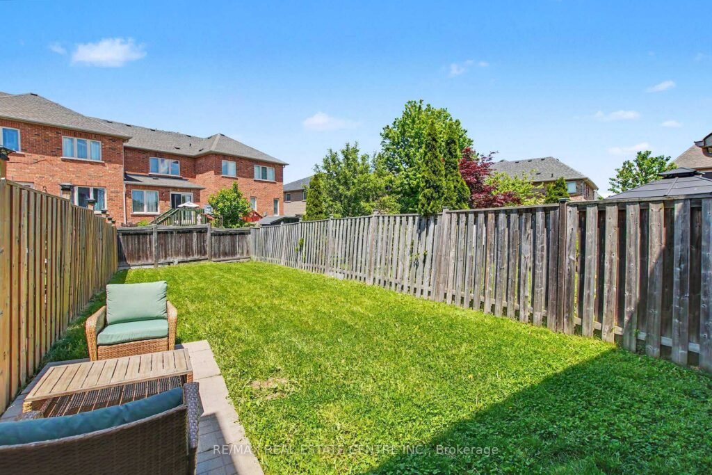94 Timbertop Crescent, Brampton - fenced backyard with lawn and patio seating